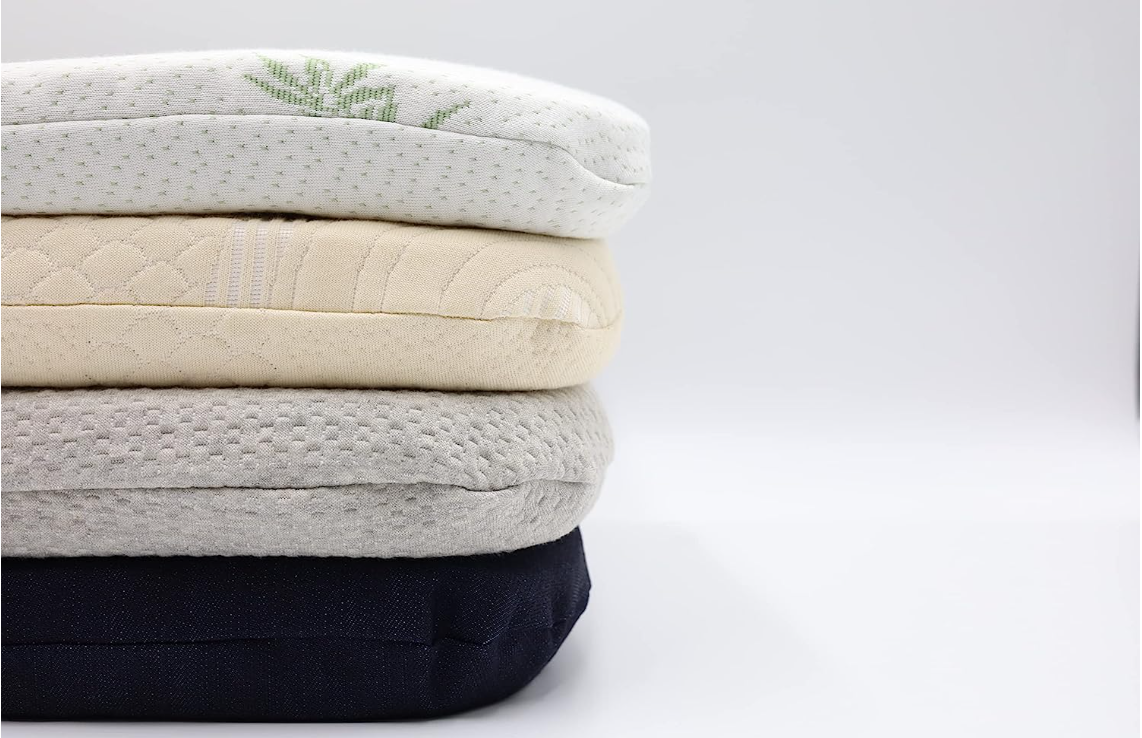 Stack of 100% organic latex seat cushions with cotton, denim, and bamboo covers in various colors on a light blue background