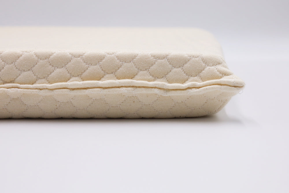 Close-up of ergonomic seat cushion showing natural latex texture and patterned surface – designed for spine alignment.