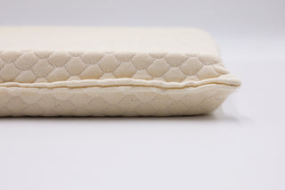 Close-up of ergonomic seat cushion showing natural latex texture and patterned surface – designed for spine alignment.