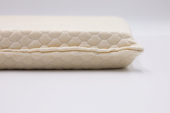 Close-up of ergonomic seat cushion showing natural latex texture and patterned surface – designed for spine alignment.