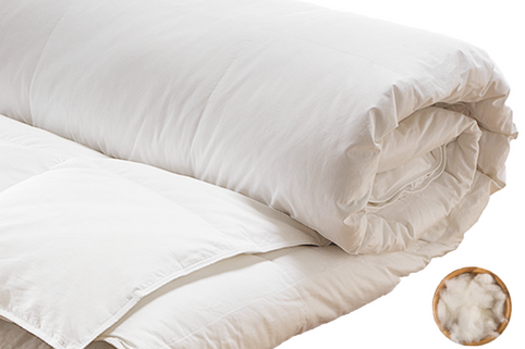 partially rolled up natural wool comforter. and the wool fiber that is filled into the comforter.